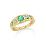 A gold ring featuring a curved band with a large round round-cut green center stone and four smaller round green accent stones.