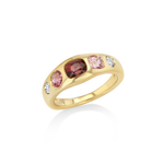 A yellow gold ring featuring a row of pink and red gemstones with small clear accent stones, shown on a clean white background.
