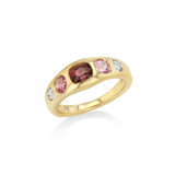 A yellow gold ring featuring a row of pink and red gemstones with small clear accent stones, shown on a clean white background.