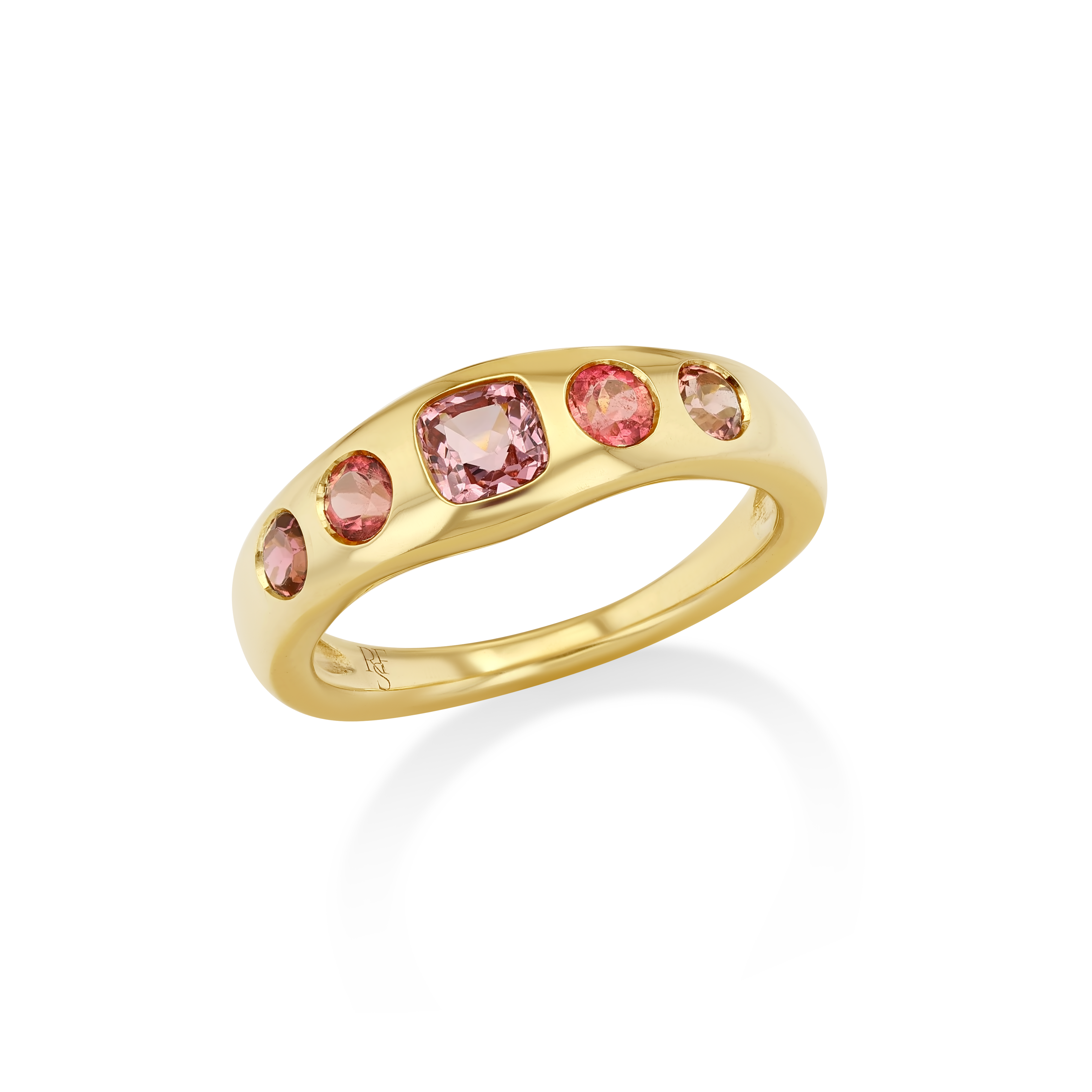 A gold band ring featuring five pink gemstones of varying sizes.