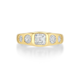 A yellow gold ring featuring a large emerald-cut diamond in the center flanked by four smaller round diamonds.