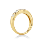 A polished yellow gold ring featuring three small clear gemstones set along the upper curve.