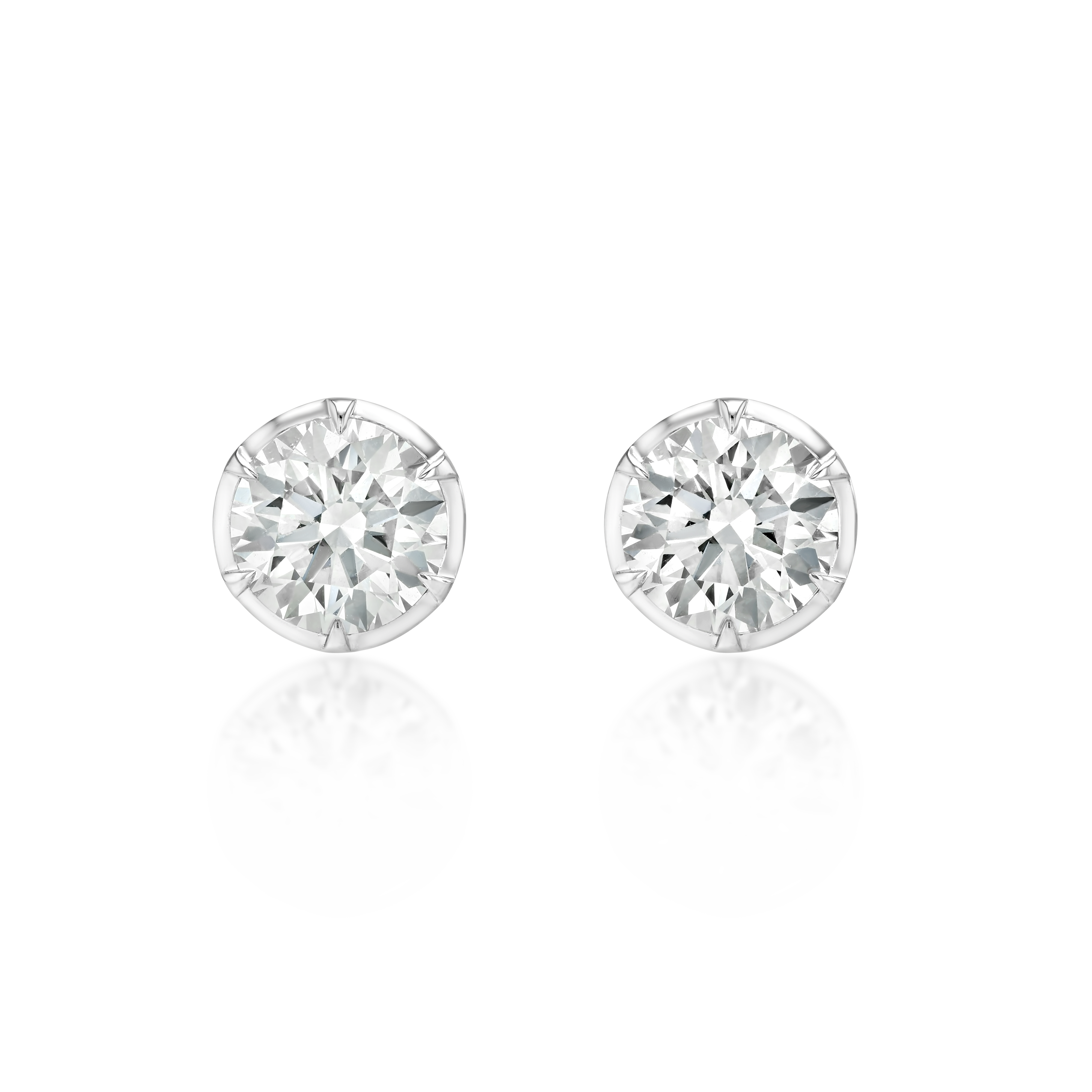 A pair of round brilliant-cut diamond stud earrings in a silver-toned setting, displayed on a clean white background with a soft reflection below.