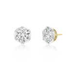 A pair of round brilliant-cut diamond stud earrings in a silver-toned setting, with one earring facing forward and the other angled to show the post and back, on a white background with a soft reflection.