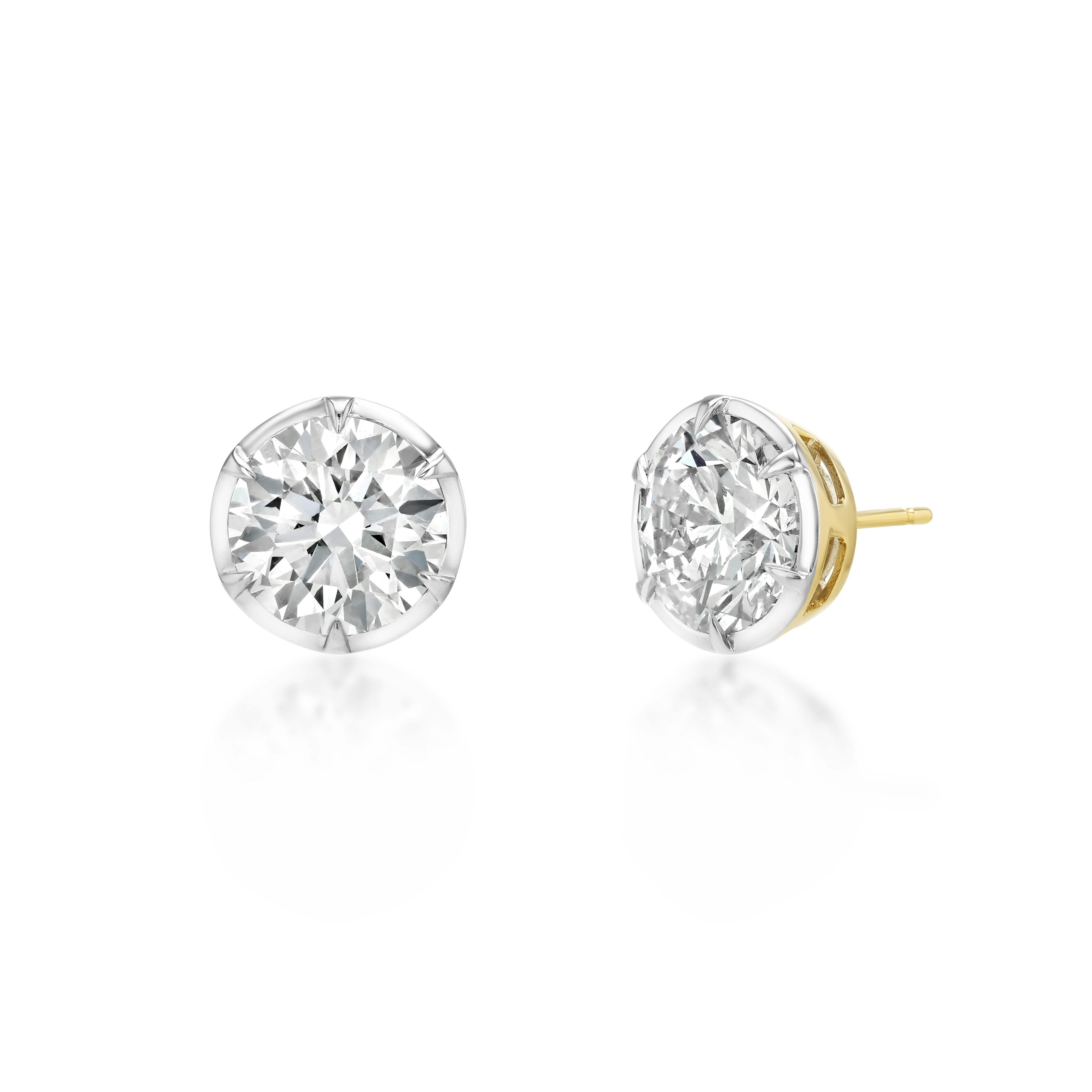 A pair of round brilliant-cut diamond stud earrings in a silver-toned setting, with one earring facing forward and the other angled to show the post and back, on a white background with a soft reflection.