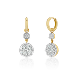 A pair of gold and white gold drop earrings with round-cut diamonds, shown on a clean white background with a soft reflection below.