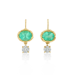A pair of gold drop earrings featuring oval green emerald-cut stones and a round clear diamond hanging below each, set against a plain white background.