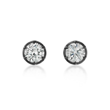 A pair of round-cut stud earrings with brilliant clear gemstones in dark metal bezel settings, shown on a clean white background with soft reflections below.
