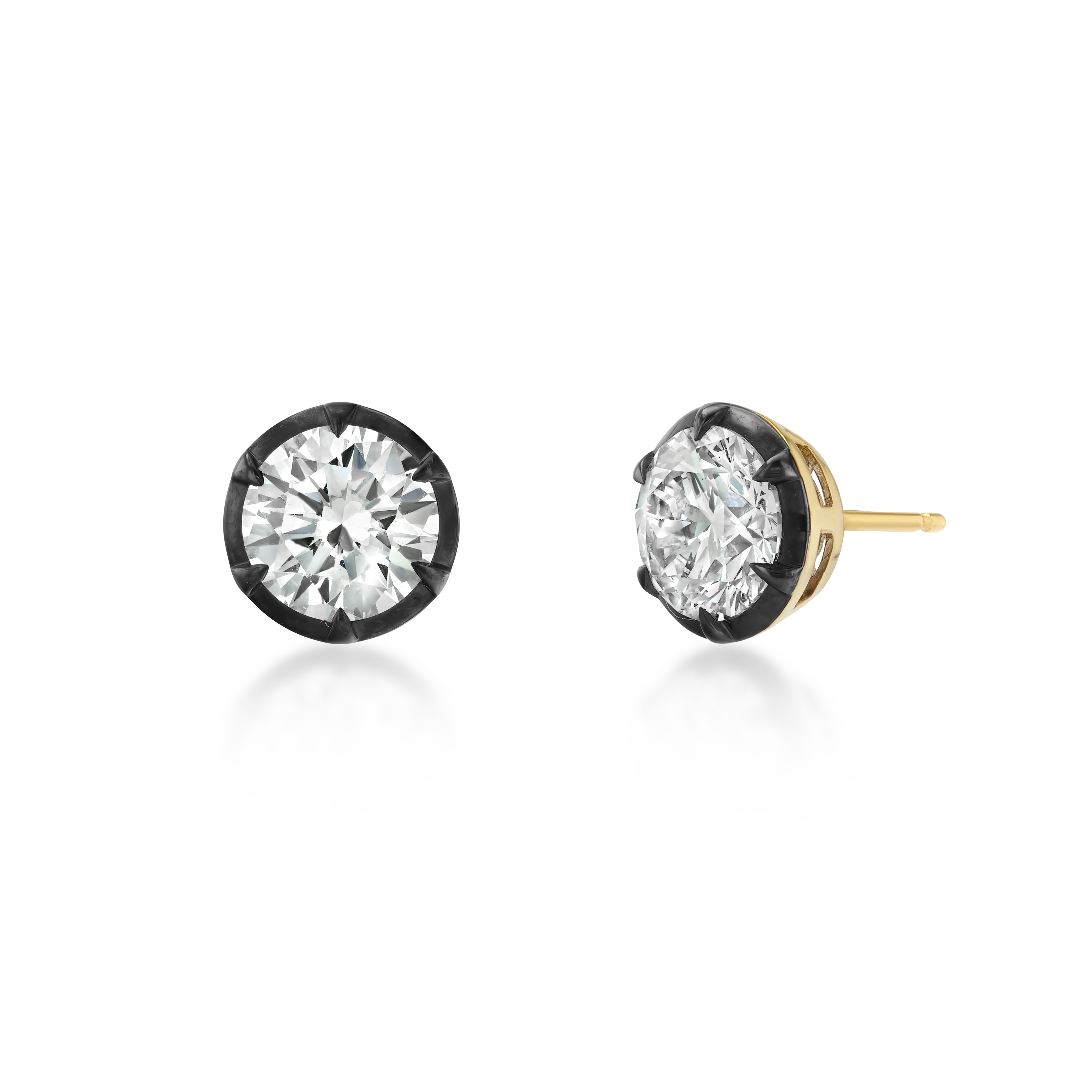 A pair of round-cut stud earrings with clear gemstones in black bezel settings and yellow gold posts, shown on a clean white background.