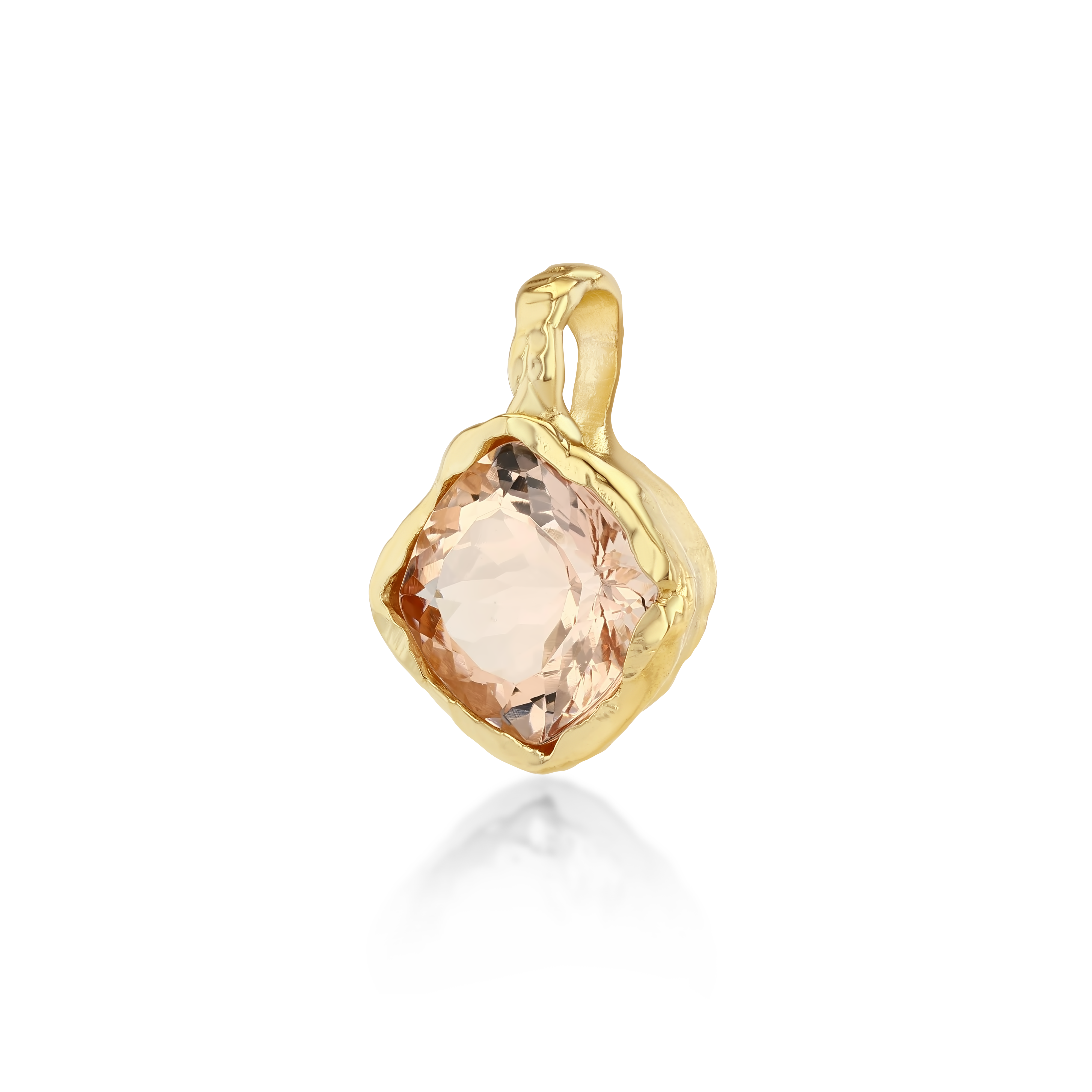 A gold pendant featuring a large, rough-cut peach-colored gemstone, shown on a clean white background with a soft reflection below.