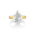 Mega Pear Button Back Pinky Ring crafted in 14k yellow and white gold, featuring a 1.5ct lab-grown pear diamond. Designed in a pear-shaped silhouette as a reimagining of the Mega Marquise style and made specifically to fit the pinky.