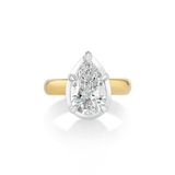 Mega Pear Button Back Pinky Ring crafted in 14k yellow and white gold, featuring a 1.5ct lab-grown pear diamond. Designed in a pear-shaped silhouette as a reimagining of the Mega Marquise style and made specifically to fit the pinky.