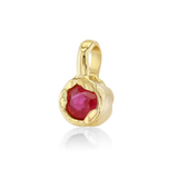 A gold pendant featuring a faceted round red gemstone in a textured, organic-shaped bezel setting, shown on a clean white background with a soft reflection.
