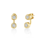 Pair of gold stud earrings featuring two round, diamonds on each earring. The gemstones are bezel-set in hammered yellow-gold settings, with one stone positioned above the other in a short vertical drop.