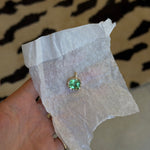 Paraiba electric green stone hammered in yellow gold in jewelers white paper